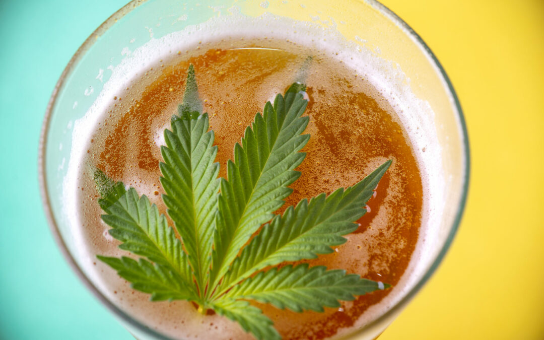 Detail of cold glass of beer with cannabis leaf
